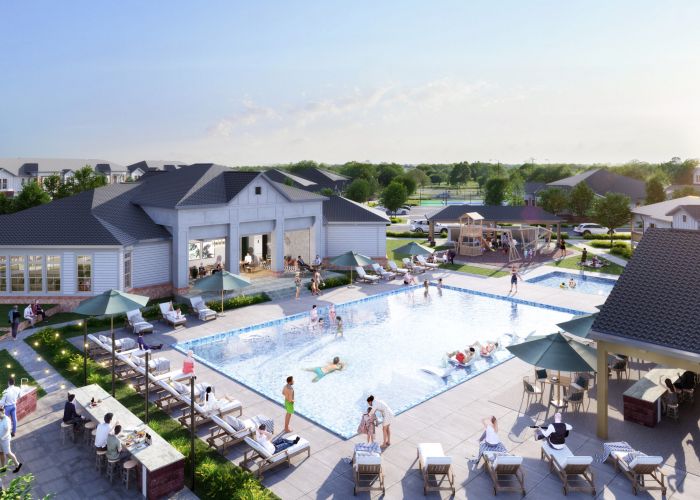 A community swimming pool area with people lounging, swimming, and socializing, surrounded by greenery and residential buildings under a clear sky. A whole new way to live: introducing the Lodges at Fort Mill.